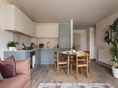 a kitchen and living room with a table and chairs at Charles Hope Cambridge in Cambridge