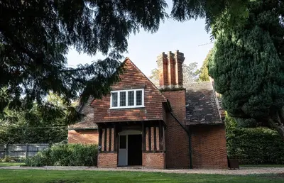 an old brick house with two chimneys on it at Idyllic, Private and Picturesque Cottage in Newmarket