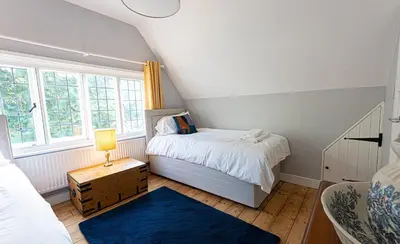 a small bedroom with a bed and a window at Idyllic, Private and Picturesque Cottage in Newmarket