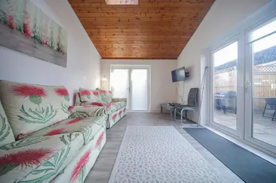 a living room with a couch and a window at A12 & A14 Location - Suffolk IP3 - Secure Parking x3 in Nacton