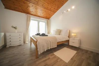 a bedroom with a large bed and a window at A12 & A14 Location - Suffolk IP3 - Secure Parking x3 in Nacton