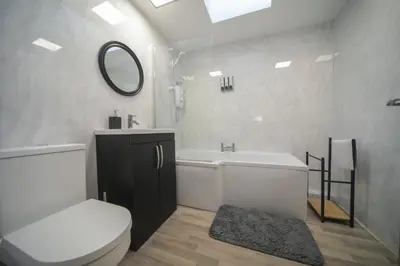 a bathroom with a toilet and a sink and a mirror at A12 & A14 Location - Suffolk IP3 - Secure Parking x3 in Nacton