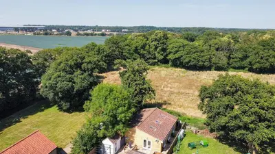 an aerial view of a house with trees and a river at A12 & A14 Location - Suffolk IP3 - Secure Parking x3 in Nacton