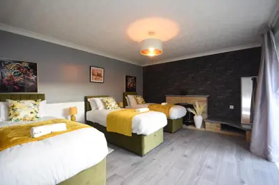 a bedroom with two beds and a fireplace at Ideal Contractor & Family Stay-Basildon Smart tv in Nevendon