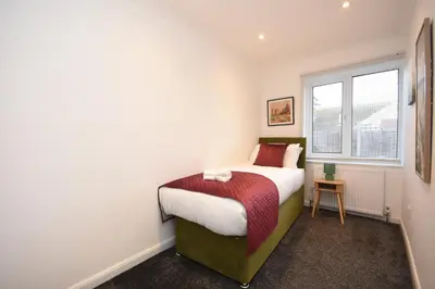 a bedroom with a bed and a window at Ideal Contractor & Family Stay-Basildon Smart tv in Nevendon