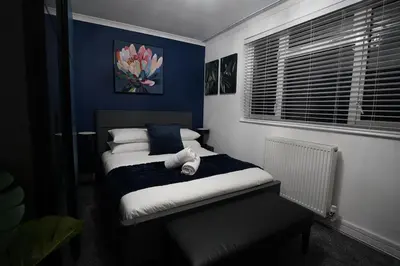 a bedroom with a bed with a teddy bear on it at Premium 3BR House - Loughton - by Rent Squared LTD in Loughton