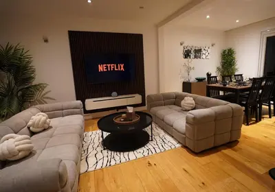 a living room with two couches and a television at Premium 3BR House - Loughton - by Rent Squared LTD in Loughton