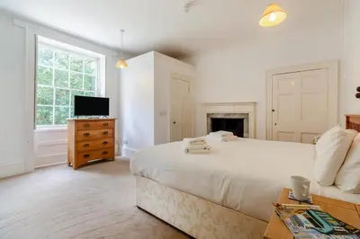 a white bedroom with a bed and a tv at 9 Bed in Three Holes oc-l31856 in Upwell