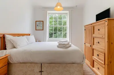 a bedroom with a large bed and a window at 9 Bed in Three Holes oc-l31856 in Upwell