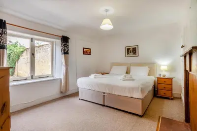 a bedroom with a large bed and a window at 9 Bed in Three Holes oc-l31856 in Upwell