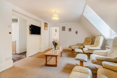 a living room with couches and a table at 9 Bed in Three Holes oc-l31856 in Upwell