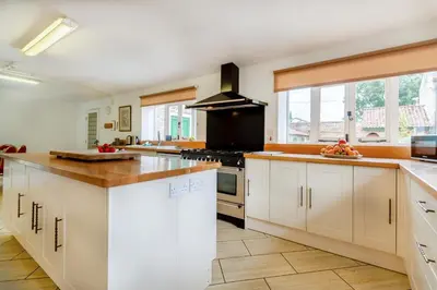 a large kitchen with white cabinets and a stove at 9 Bed in Three Holes oc-l31856 in Upwell