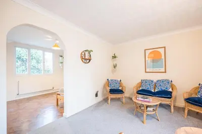 a living room with chairs and a table at Flat Two, High Street in Saxmundham