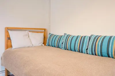 a bedroom with a bed and a pillow at Flat Two, High Street in Saxmundham