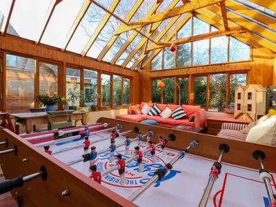 a living room with a large ping pong table at Town Farm in Eye