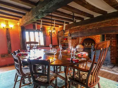 a dining room with a wooden table and chairs at Town Farm in Eye