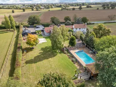 an aerial view of a home with a swimming pool in a yard at Luxury Spa Mansion With Heated Pool and Spa Facilities in Stanningfield