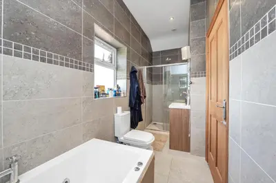 a bathroom with a toilet and a shower and a sink at Luxury Spa Mansion With Heated Pool and Spa Facilities in Stanningfield