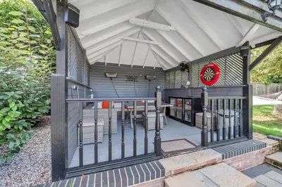 a house with a porch with a fence at Luxury Spa Mansion With Heated Pool and Spa Facilities in Stanningfield