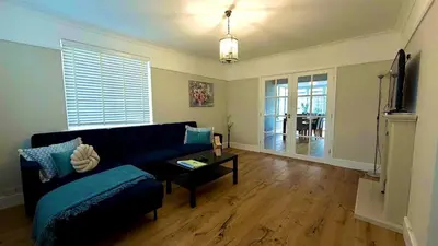 a living room with a couch and a tv at Aughamore Home in CBG