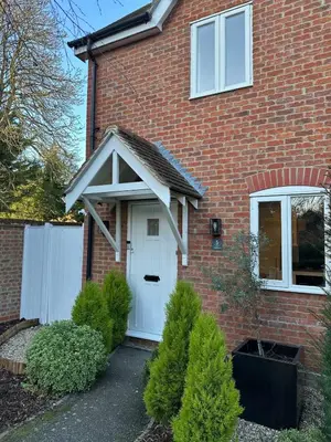a red brick house with a white door at The Waldegraves Hideaway in Bures Saint Mary