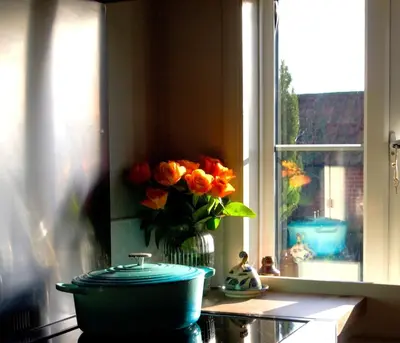 a vase of flowers sitting on a counter next to a window at Beautiful Four Bedroom Cottage in Little Glemham, Suffolk in Little Glenham