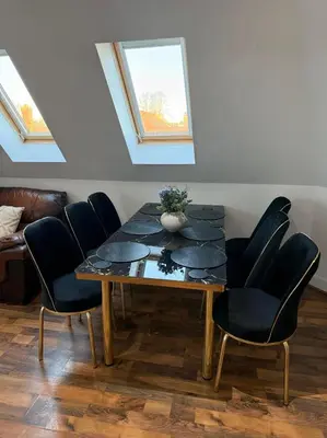 a dining room with a table and chairs at Two-Bedroom Attic House in Colchester