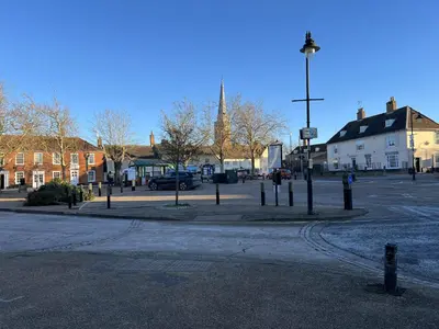an empty street in a town with a street light at Siskin House in Wickham Market