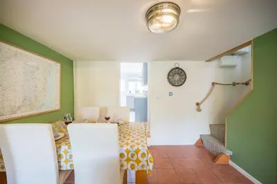 a room with a table and a clock on the wall at 1 Lavender Cottages, Knodishall in Saxmundham