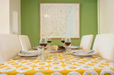 a table with wine glasses and a map on the wall at 1 Lavender Cottages, Knodishall in Saxmundham