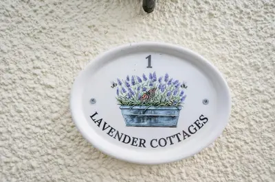 a plate with a flower pot with a butterfly on it at 1 Lavender Cottages, Knodishall in Saxmundham