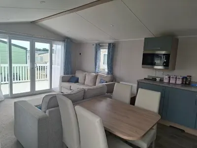 a living room with a table and a couch at Life is Adventure in Great Clacton