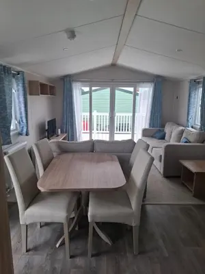 a living room with a table and chairs and a couch at Life is Adventure in Great Clacton