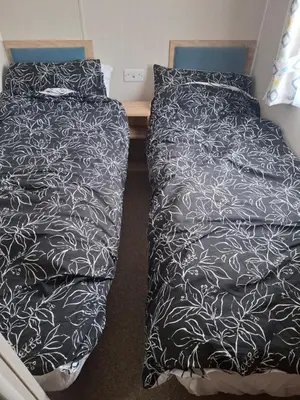 two beds sitting next to each other in a room at Life is Adventure in Great Clacton