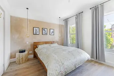 a bedroom with a bed and a large window at Stunning 2Bed Central Home in Cambridge