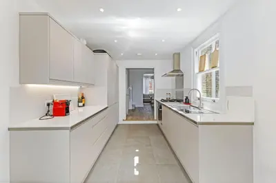 a white kitchen with white cabinets and a sink at Stunning 2Bed Central Home in Cambridge