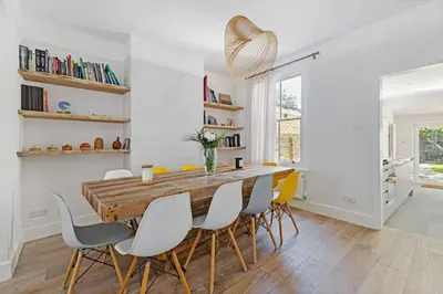 a dining room with a wooden table and chairs at Stunning 2Bed Central Home in Cambridge