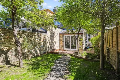 a brick house with a yard with trees at Stunning 2Bed Central Home in Cambridge