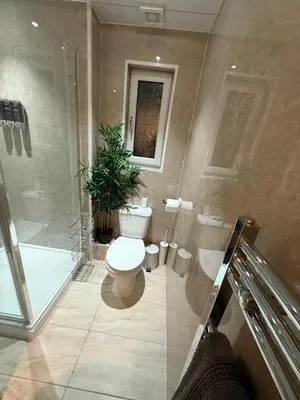 a bathroom with a toilet and a shower and a sink at Large 5BR House with FREE Parking and WiFi plus Garden in Basildon, Essex in Basildon