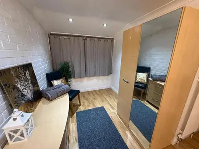 a living room with a couch and a fireplace at Large 5BR House with FREE Parking and WiFi plus Garden in Basildon, Essex in Basildon