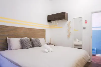 a bedroom with a white bed with a television on the wall at 1BR Super King sized Apartment Contractor friendly - Free Parking! in Southend-on-Sea