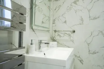 a white bathroom with a sink and a mirror at 1BR Super King sized Apartment Contractor friendly - Free Parking! in Southend-on-Sea