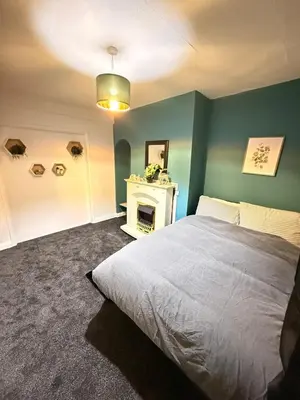 a bedroom with a bed and a fireplace at Royal 4 Bed House By City Centre in CBG
