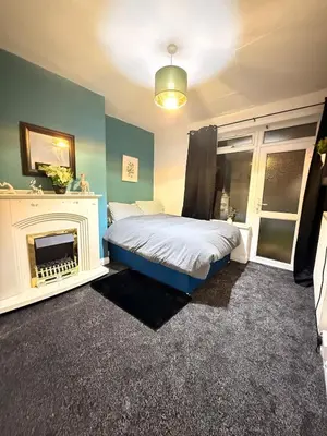 a bedroom with a bed and a fireplace at Royal 4 Bed House By City Centre in CBG