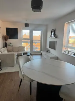 a living room with a table and a couch at 2 Bed apartment- Laindon in Great Burstead