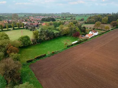 an aerial view of a field and a town at Hare View, part of The Garden House in Kenninghall