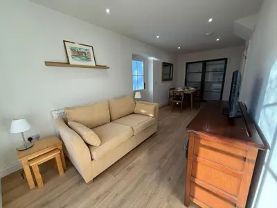 a living room with a couch and a table at The Coach House in Halstead