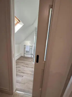 an open door to a room with a hallway at The Coach House in Halstead