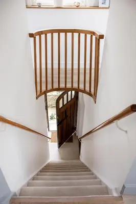 a stairway leading up to a wooden door at 1 Quay Cottage in Bawdsey