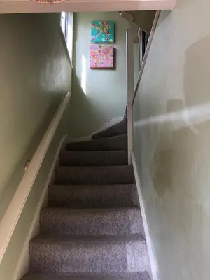 a staircase in a house with a painting on the wall at 'The Artist's Loft' - Studio Flat in Cambridge in Cambridge